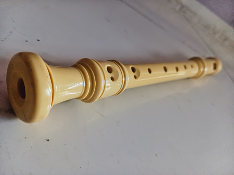 Traditional handmade wooden flute - folk musical instrument that belongs to woodwind group.