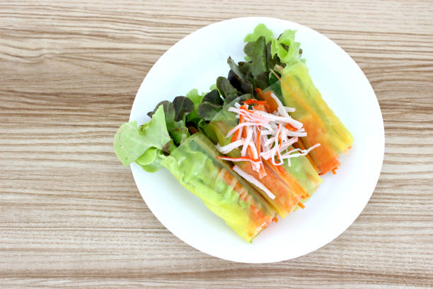 Crab stick salad roll in white dish on the table