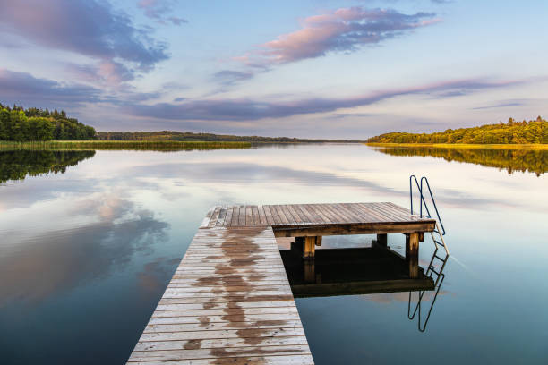 istock Bathing jetty at the lake Schaalsee during sunrise in Seedorf, Germany 1686649670