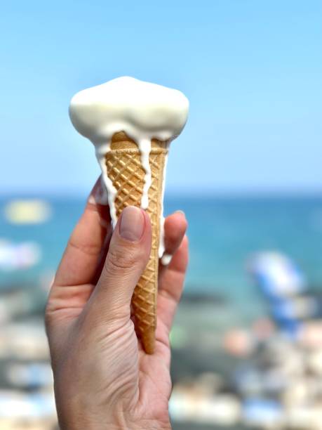istock A girl holds melted ice cream in a waffle cone in her hands. 1686652312