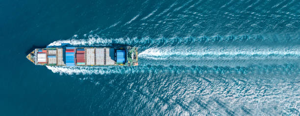 istock Cargo container Ship, cargo maritime ship with contrail in the ocean ship carrying container and running for export concept technology freight shipping sea freight by Express Ship. top view 1686655514