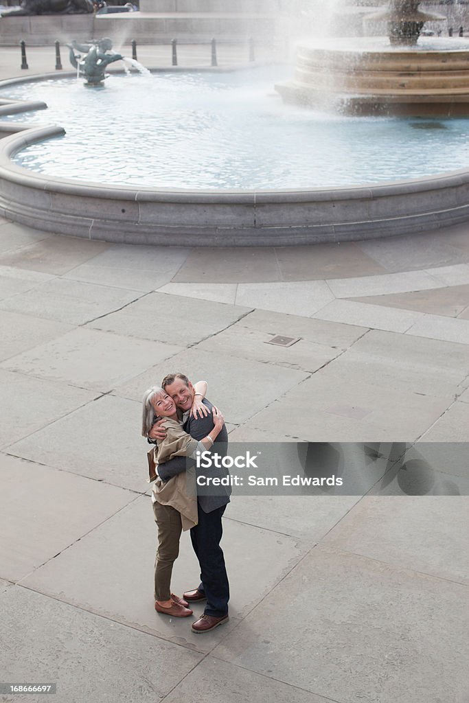 Couple hugging near fountain  Mature Couple Stock Photo