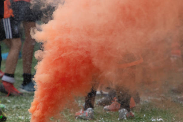 orange smoke from celebrating a football championship, with boots and socks