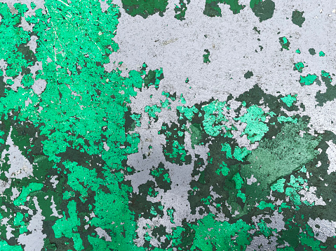 Old peeling green paint on a wall