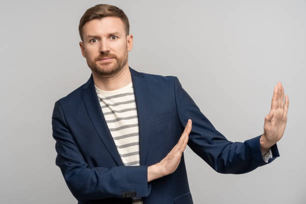 istock Man with disgust on face pushes negative space away from himself, moving away problems isolated 1686716058