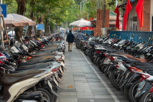Very long lines of parked motorcycles in downtown Hanoi, Vietnam
