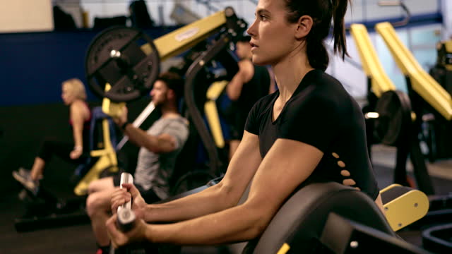Dedicated Fitness: Woman Targeting Biceps at the Gym