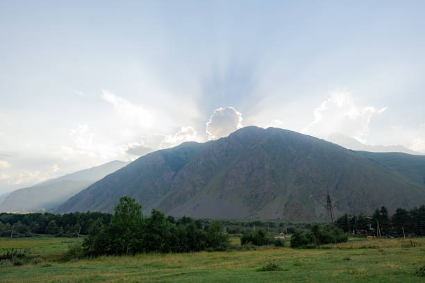 Scenic view of mountains backit by sun at sunset in Kazbegi region