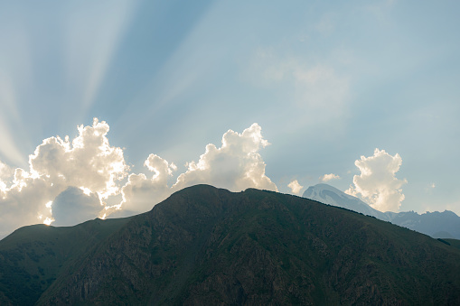 Scenic view of mountains backit by sun at sunset in Kazbegi region