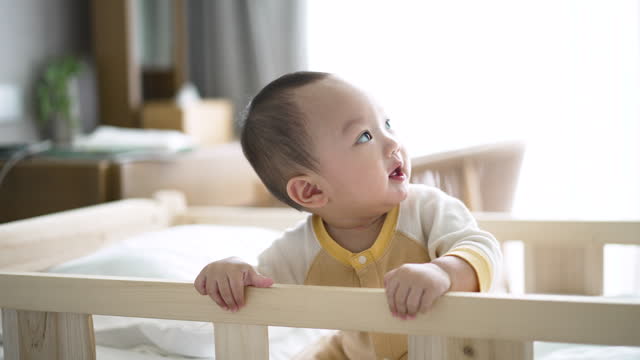 Baby Boy Happy and funny on baby bed in bedroom in the morning time