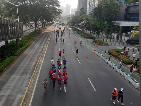 Jakarta, Indonesia, September 17, 2023: Sunday is car free day, people are free to exercise even though it is sunburned, by running, cycling, jogging or taking a leisurely walk, having fun together.