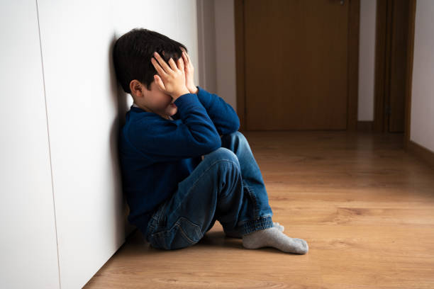 istock sad child with head in hands sitting on floor 1686738352