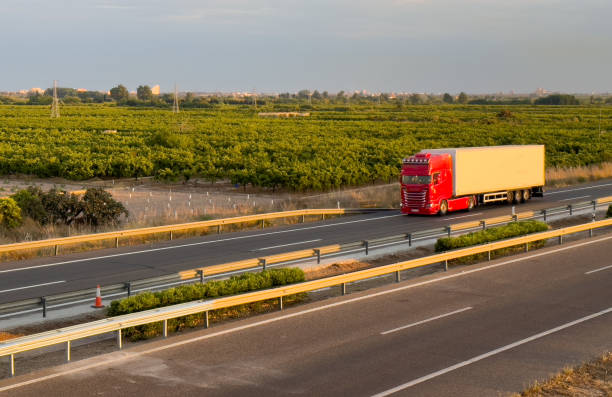 istock Semi truck with Semi-trailer driving along highway. 1686742206
