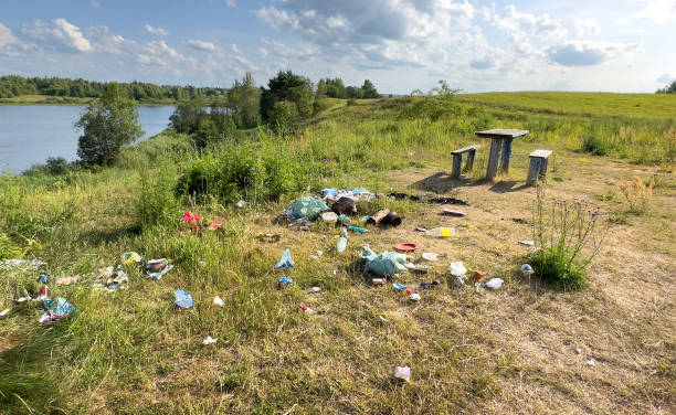 istock Garbage dump in Illegal location. People throw garbage near lake in nature. 1686744446