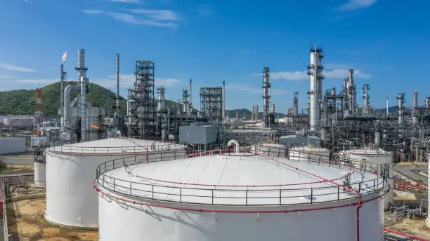 Photo of Oil and Gas refinery petrochemical plant industrial with oil and gas storage tank, White oil and gas refinery storage tank, Aerial view Oil and gas refinery plant from industry zone.