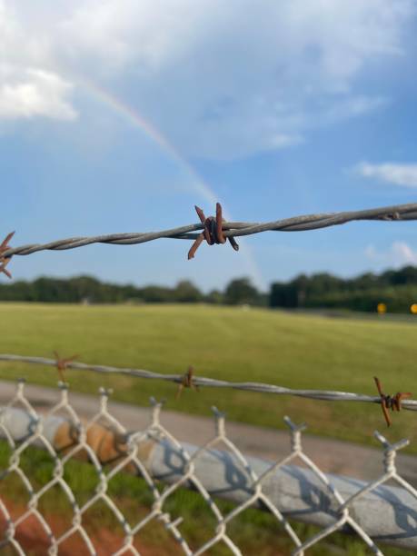 istock Bared wire in the Foreground with Rainbow in the background 1686755547