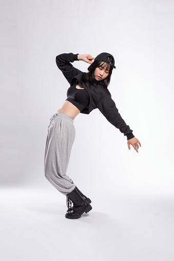 Woman Dancing in Hip-Hop Dance Attire against Gray