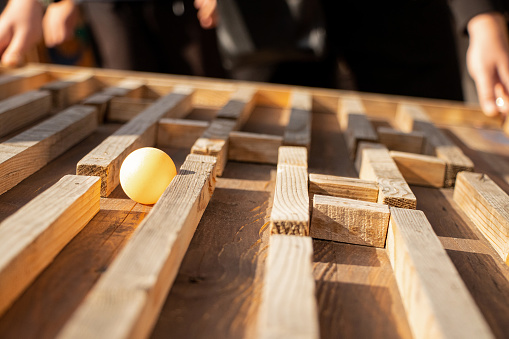 Ball in a wooden maze and find a way out, how to get out, maze game, exit of their maze, success and achievement, hobby, logic game