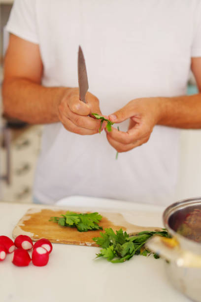 istock chef man cut parsley with a knife 1686778380