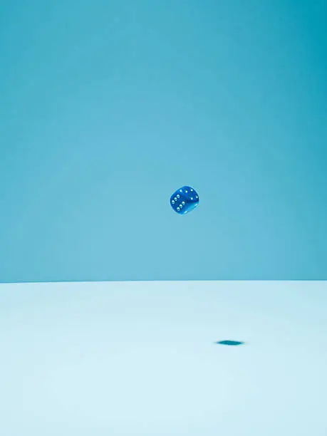 Photo of Blue dice in mid-air