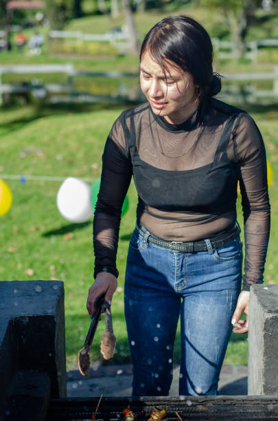 istock young woman cooking on a grill outside 1686801455