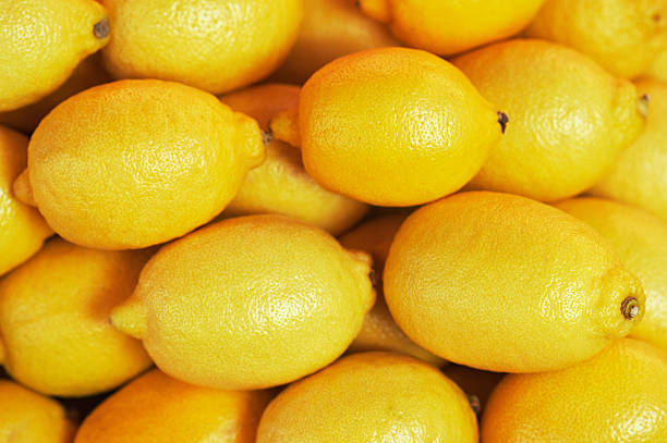 istock background, texture of many lemons in market 168680209