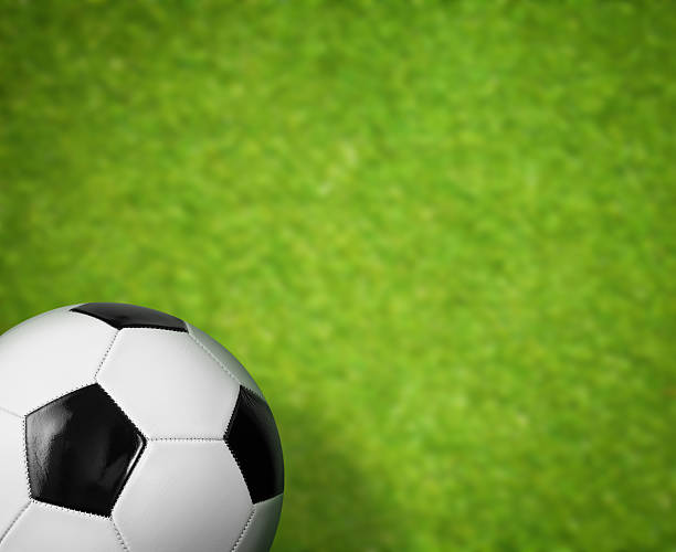 istock green grass soccer field and ball background 168680272