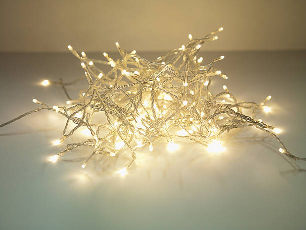груду освещенной огнями на завязках - christmas tangled christmas lights lighting equipment стоковые фото и изображения