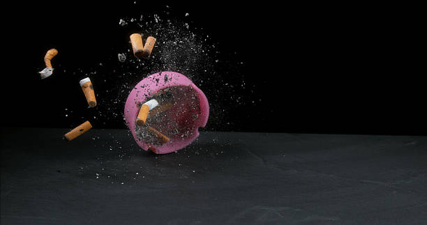 istock Ashtray filled with Megots falling on Black Background 1686812726