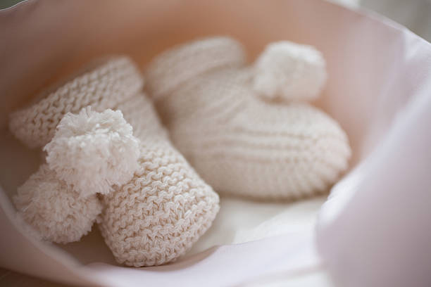 Close up of knit baby booties  baby booties stock pictures, royalty-free photos & images