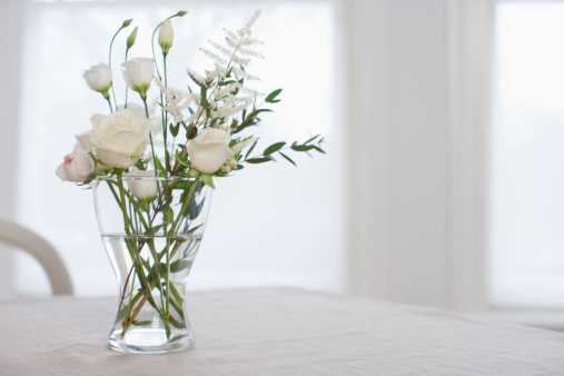 bouquet of roses in bloom on kitchen table\nPhoto taken indoors of flowers