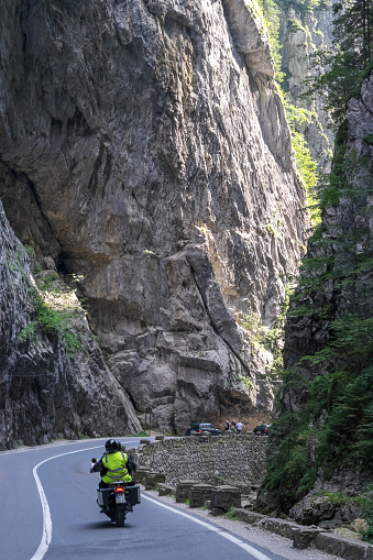 Gheorgheni, Romania - September 09, 2023: Scene with motorcycle driving on the road in the gorges of the Bicaz river