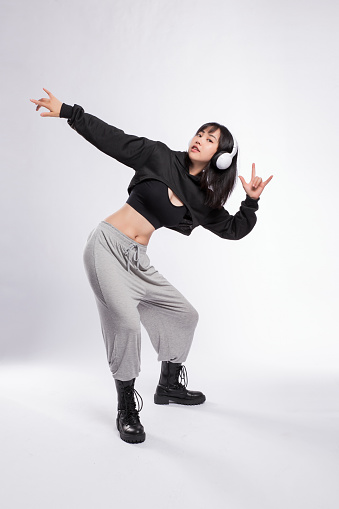 Woman Dancing in Hip-Hop Dance Attire against Gray