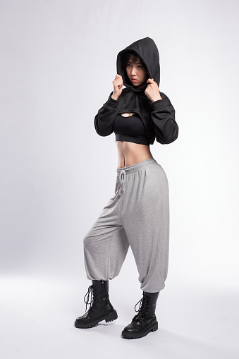 Woman Dancing in Hip-Hop Dance Attire against Gray