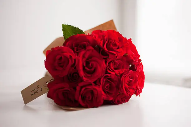 Photo of Red rose bouquet with gift tag