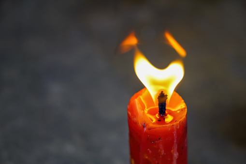 Red candle with gold flame