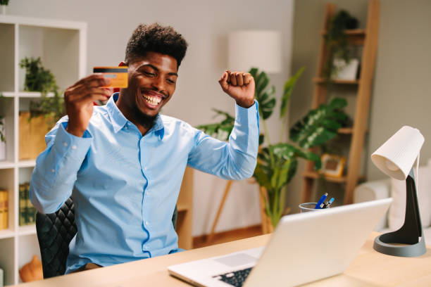 istock young man uses a credit card through a laptop on the Internet 1686890364