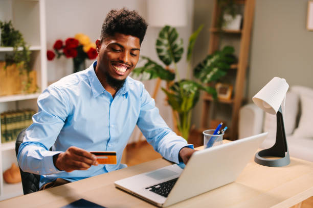 istock young man uses a credit card through a laptop on the Internet 1686890366