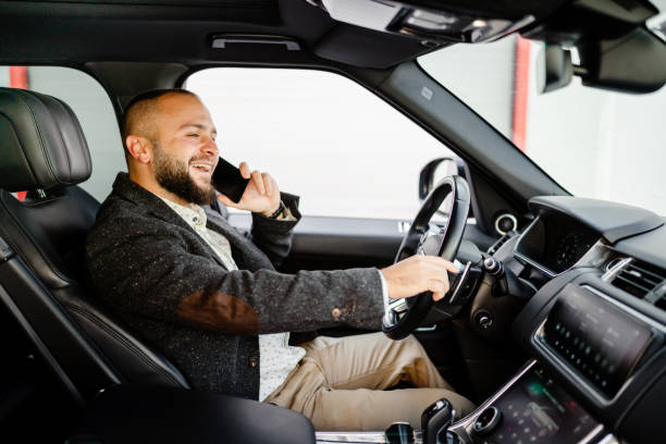 istock Successful young businessman on the phone while driving 1686903985