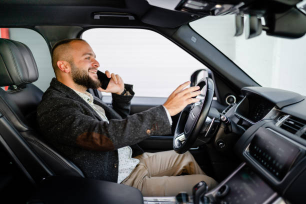 istock Successful young businessman on the phone while driving 1686903991