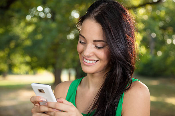 istock Young woman texting on mobile phone 168690815