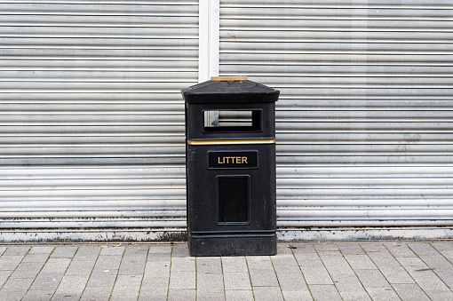 Black litter bin for rubbish in public area UK