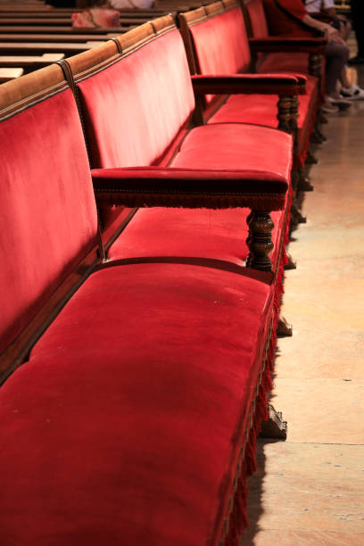 istock Red velvet covered seats inside a church 1686939444