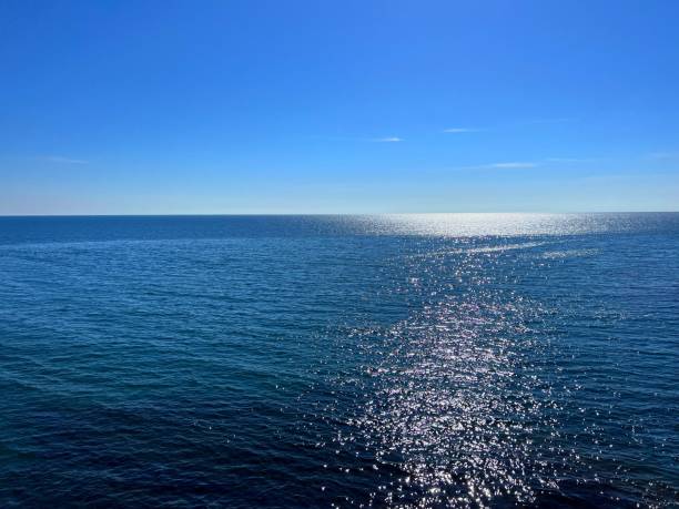 istock Blue sea water shiny silver surface and sunny clear sky. 1686997981