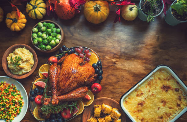 istock Preparing stuffed turkey with side dishes for Thanksgiving celebration 1686998364
