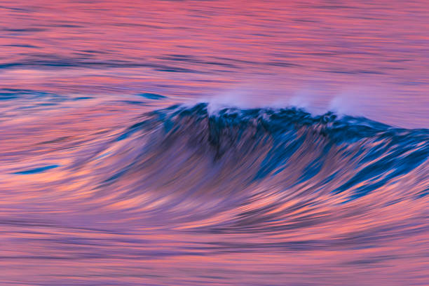 Smooth artistically captured ocean wave in golden evening light. Photographed along the coastline of South Western Australia.