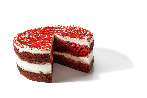 A red velvet cake, isolated on a white background. A red velvet cake is a soft red velvet treat with a perfect balance of sweet and tart, topped with a silky, creamy layer of cream cheese frosting.