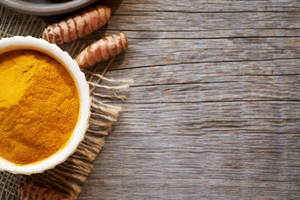istock Turmeric powder and root on a rustic wooden background with sopy space 1687015677