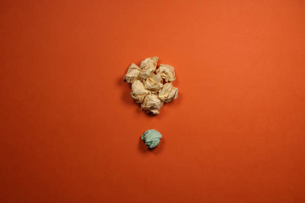 Crumpled paper balls on orange background