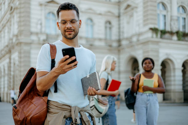 istock Young Caucasian male student checking his phone 1687034069